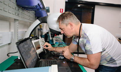 Man turning knob on machine