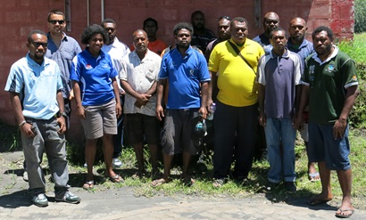 A group of people standing together outside.