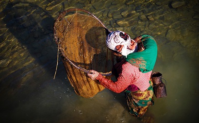 Woman looking in fishing net