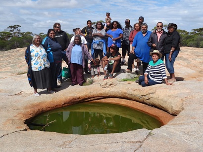 Buldania Rocks. Ngadju showing researchers a rockhole that needs to be cleaned out.