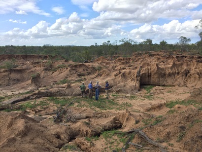Four CSIRO researchers standing in an eroded gully.