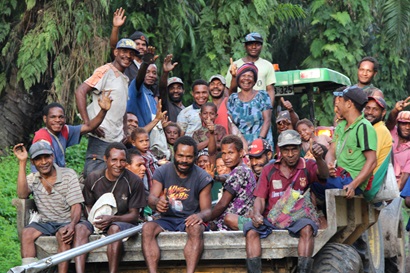 A large group of people in Papua New Guinea sitting on the back of a truck