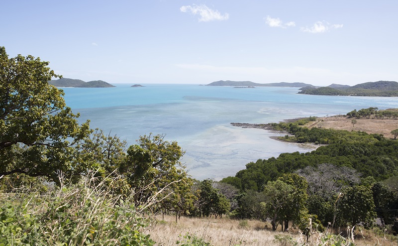 View from an island out over blue waters with other islands in the distance