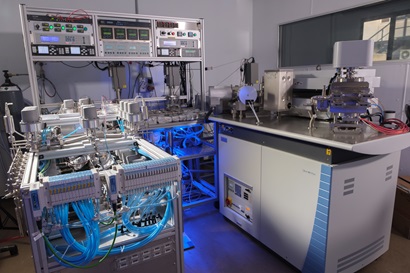 The large and complex  noble gas mass spectrometer HELIX machine. It is mostly silver with lots of pipes, recording equipment and work benches. The HELIX is located at the CSIRO Waite Campus, Adelaide.