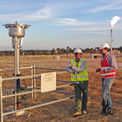 Researchers stand at a groundwater bore assessing its sustainability.