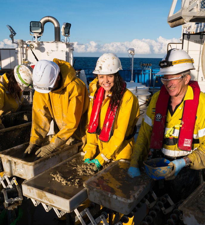 Researchers working on sorting deep ocean samples taken from the abyss.