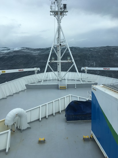 View of large wave in front of the bow of a ship.