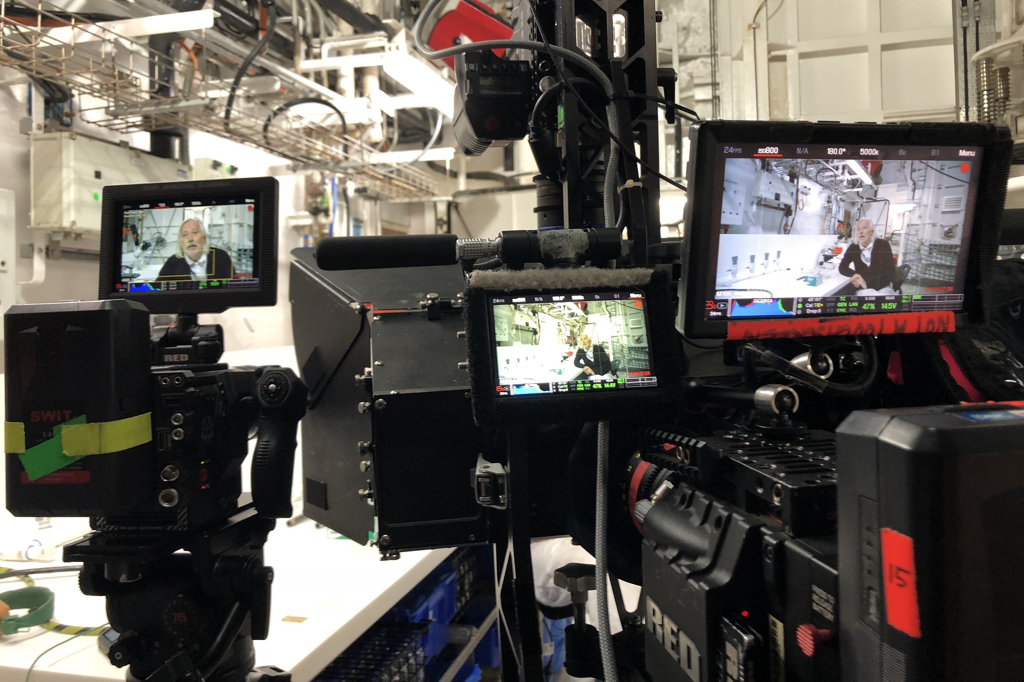 A series of camera screens show a person being interviewed.