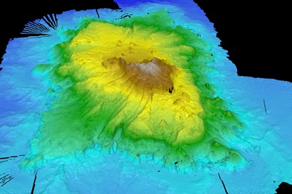 A colourful image that shows a rising mountain from the seafloor, with different colours showing height of the feature.
