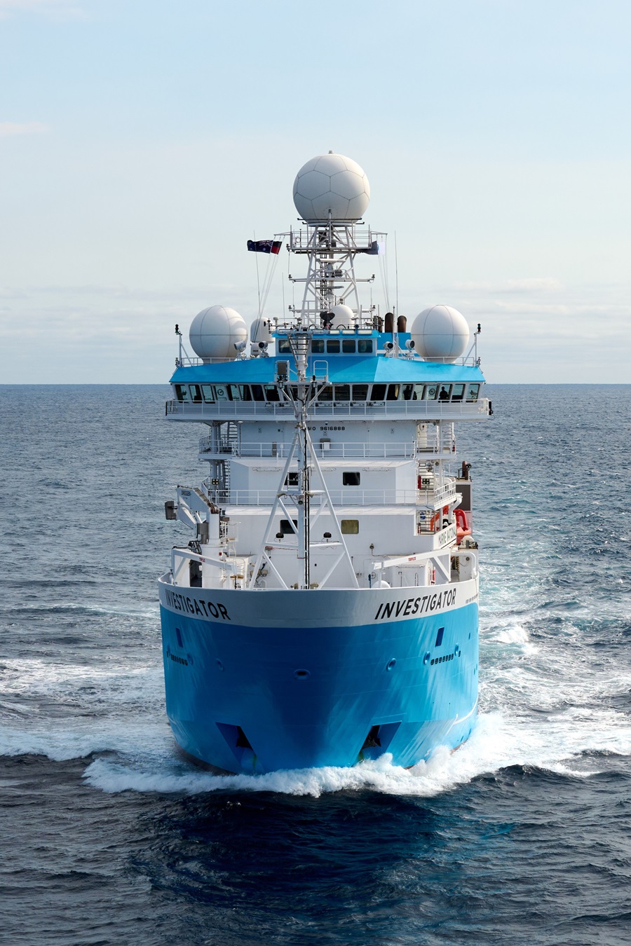 A blue and white ship on the ocean.