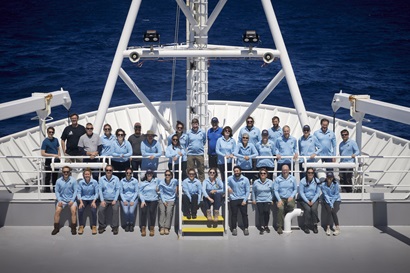 A group of people on the bow of a ship.