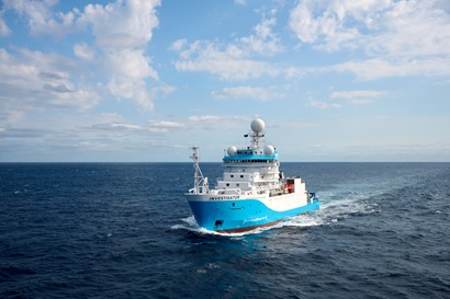 A blue and white vessel at sea.