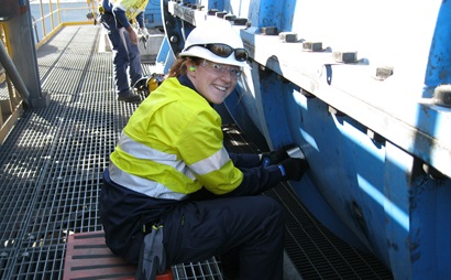 Young female engineer placing acoustic analyser on equipment