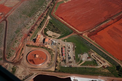 Aerial view of bauxite processing facility showing red mud ponds