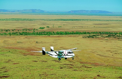 Plane flying over field undertaking aerial survey