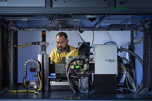 Bearded male researcher seen behind scanning instrument