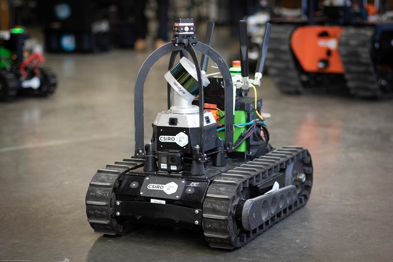 Robot with caterpillar track wheels fitted with sensing and communication equipment on top