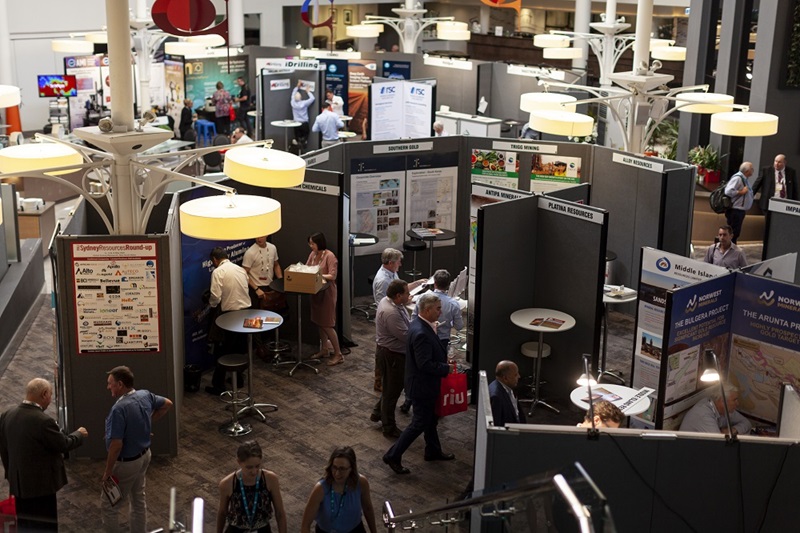 Aerial view of an exhibition hall showing people congregating between poster display boards