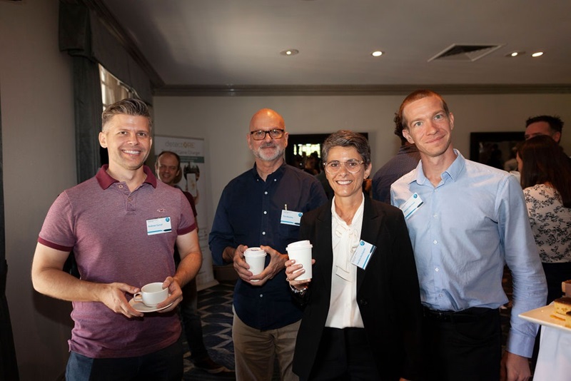 three men and one woman pictured at conference