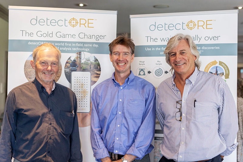 three men smiling infront of banner stating: Detect ore the gold game changer