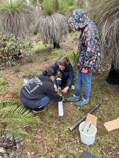 Two people collecting measured soil samples for Ultrafine+ analysis