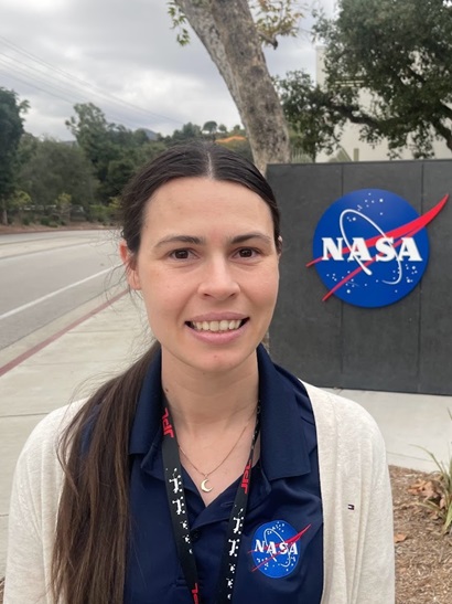 Woman standing in front of NASA sign