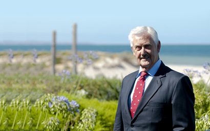 Portrait of Paul Dowd, industry leader, against a coastal background