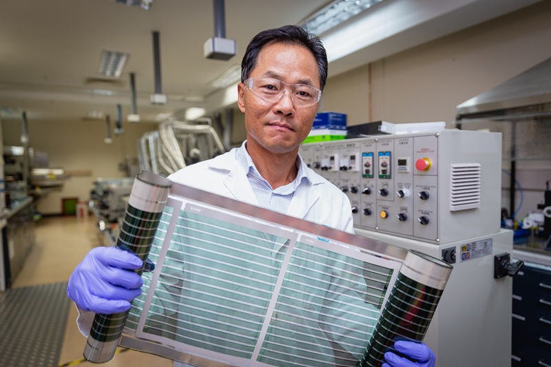 CSIRO Principal Research Scientist Dr Doojin Vak holding CSIRO-produced roll-to-roll printed solar cells in our labs
