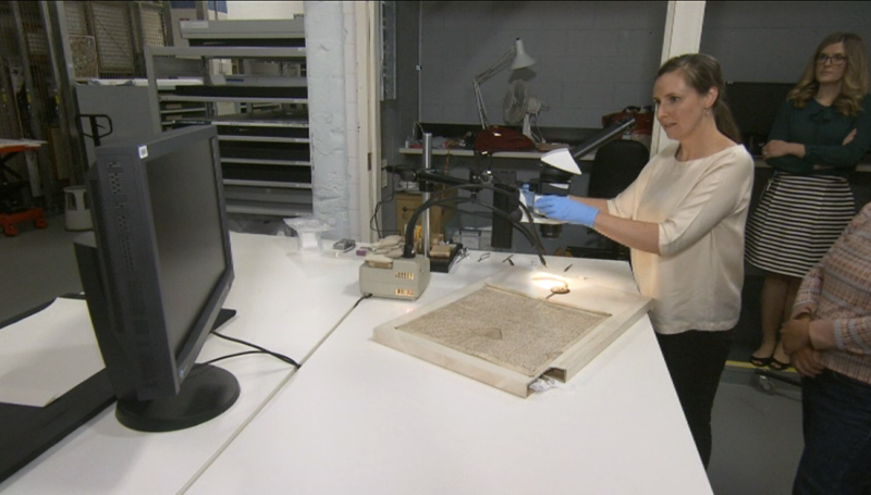 Image of Conservators inspecting the Magna Carta.