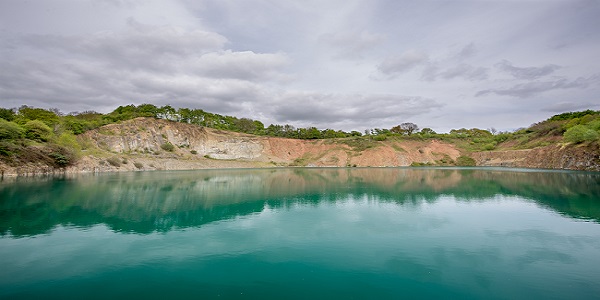 Lake with sandy banks reflected in water