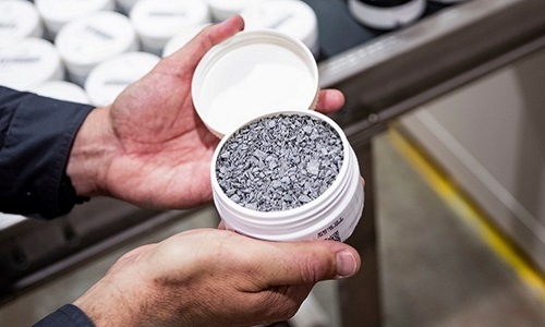 hands holding container of rock chips