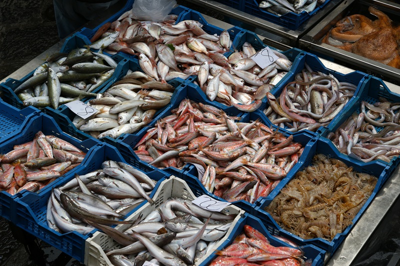 Fish in baskets for sale at a market.