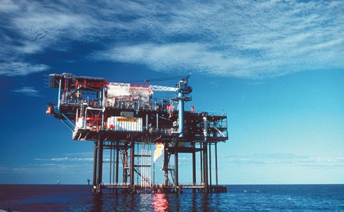 An offshore oil rig surrounded by ocean.