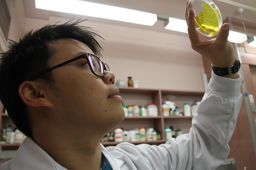 Dr Sam Lau holding up a plastic membrane that has received a Hollywood makeover.