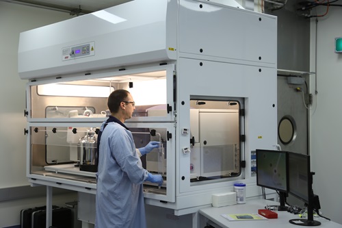 Matt Bruce, a CSIRO immunology researcher, loads a sample into the cell sorter to isolate virus fighting cells.