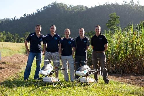 The ResQ team stand behind two UAV's.
