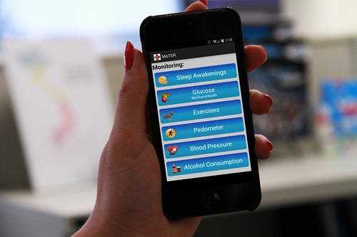 Person holding smartphone which showing the app which features health and exercise monitoring tools.