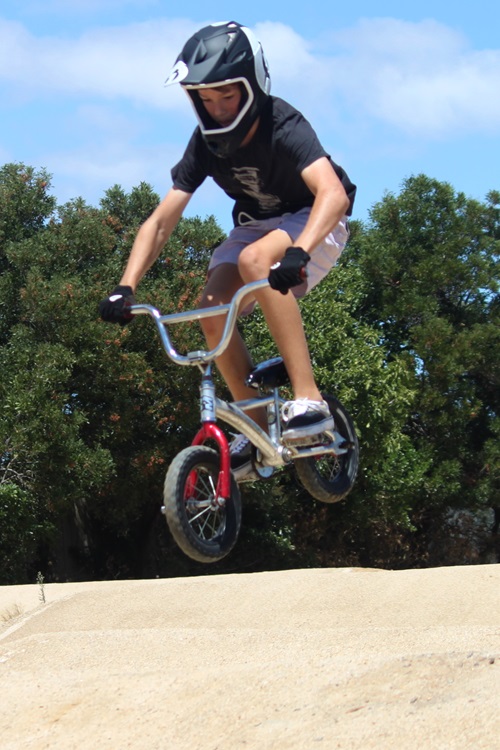 Ben on his first mini bike built out of recycled materials.