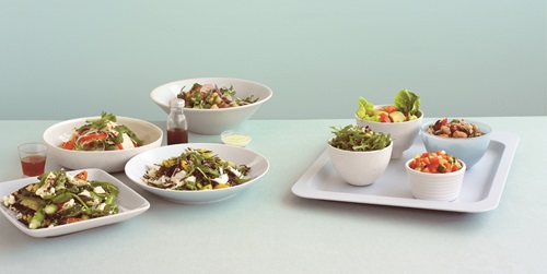 Variety of bowls holding salads. 