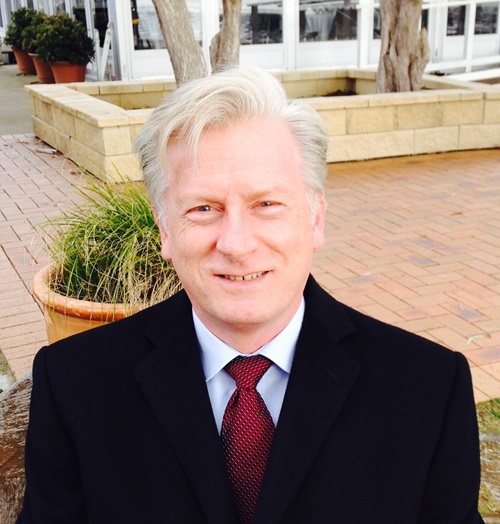 Head and shoulders of Mr Brendan Dalton, CSIRO Chief Information Officer, wearing a dark jacket and red tie.