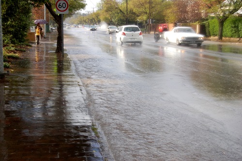 Water filled gutter along a suburban street following rainfall. 