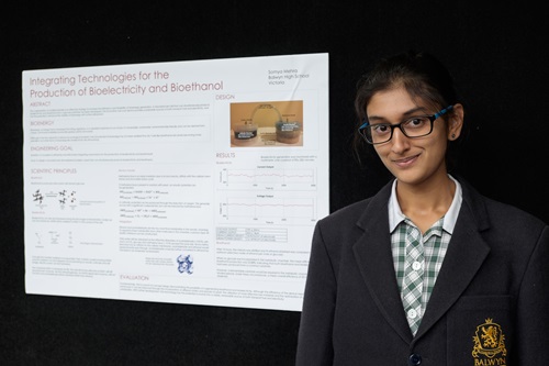 Somya Mehra stands with her science poster