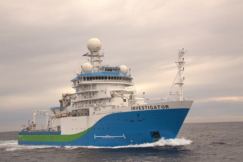 Side view of the RV Investigator at sea.