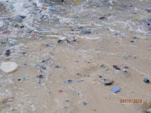 Plastic fragments washing in the surf