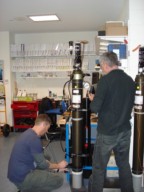 Two men working on a BioArgo robotic float.