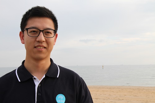 Dr Kang Liang standing in a beach.