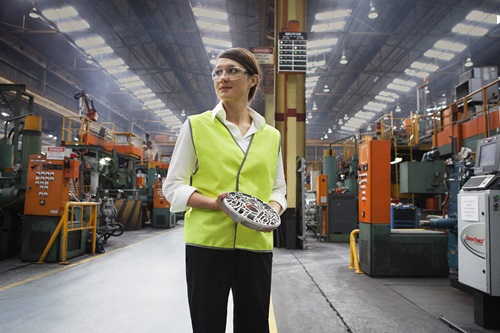 A woman wearing safety glasses and a high visibility vest at Nissan's plant in Melbourne.