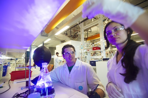 Male and female researchers working in laboratory.