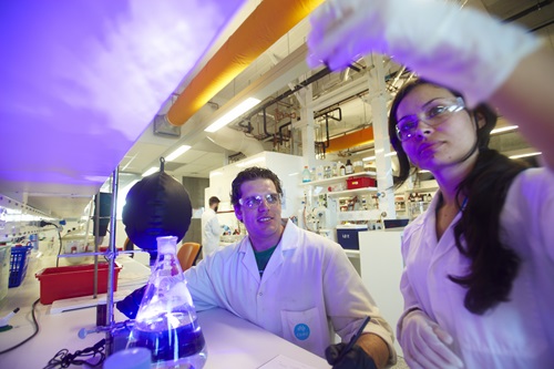 Male and female researchers working in laboratory.