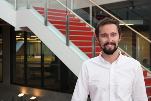 Dr Aaron Thornton in an open neck white shirt